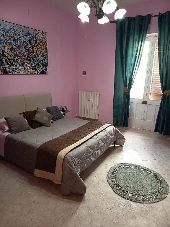 a bedroom with a bed and a painting on the wall at Casa Rosa in Sogliano Cavour