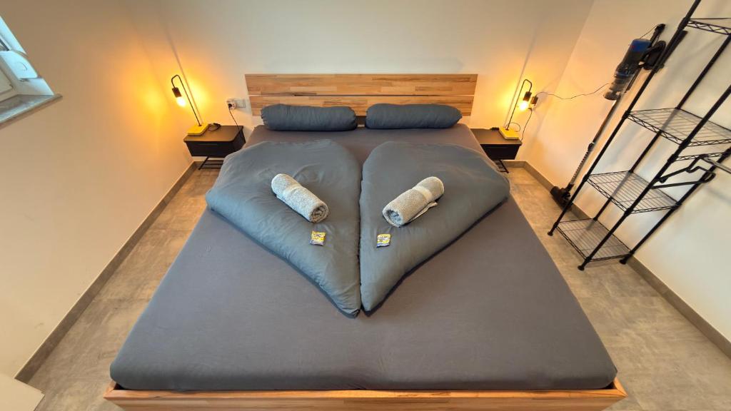 a large bed with two pillows on top of it at Apart Schwalbennest in Imst