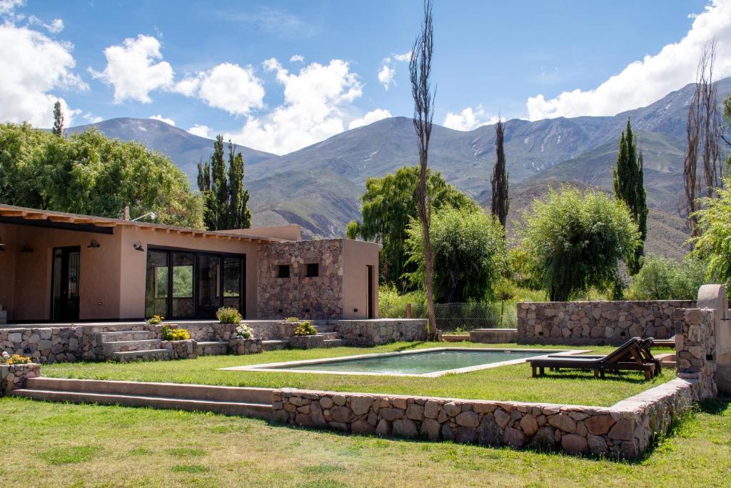 a house with a pool and mountains in the background at Villa Laureana in Huacalera