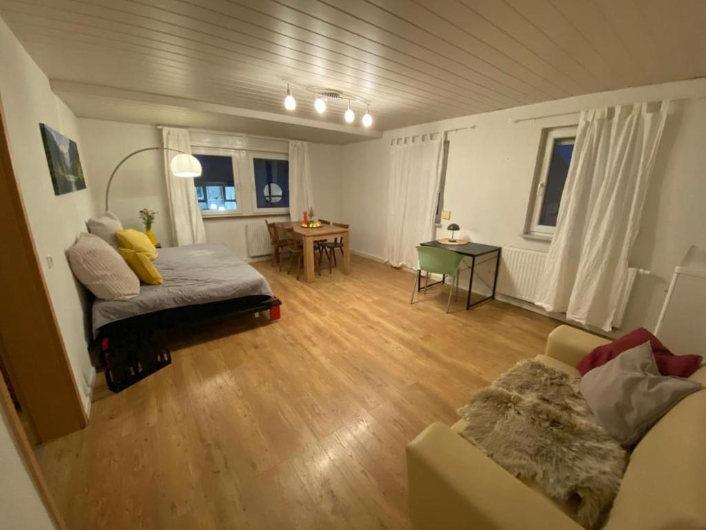 a living room with a bed and a couch at Ferienwohnung Eberhard in Schwäbisch Gmünd