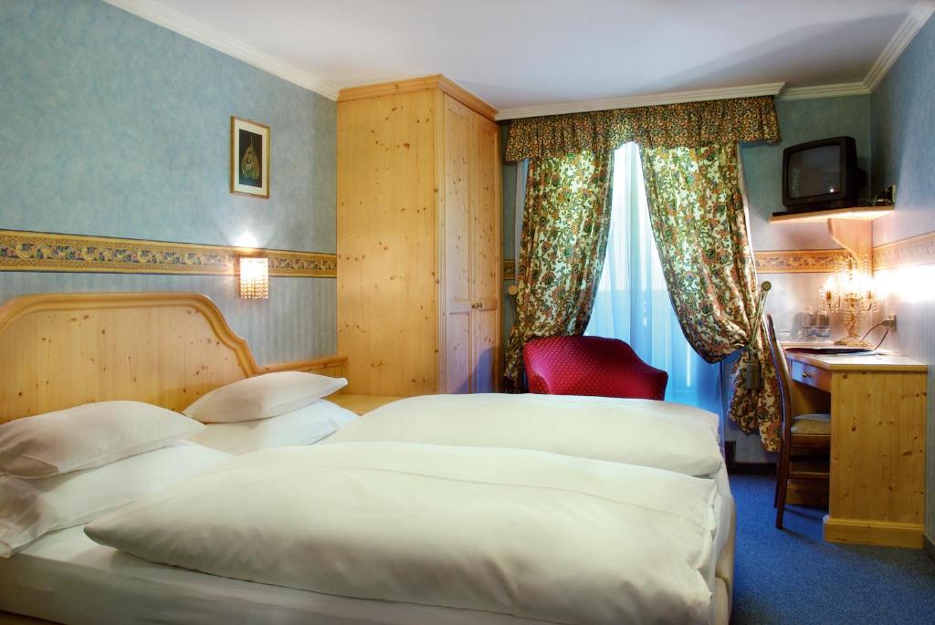 Postel nebo postele na pokoji v ubytování Hotel Evaldo