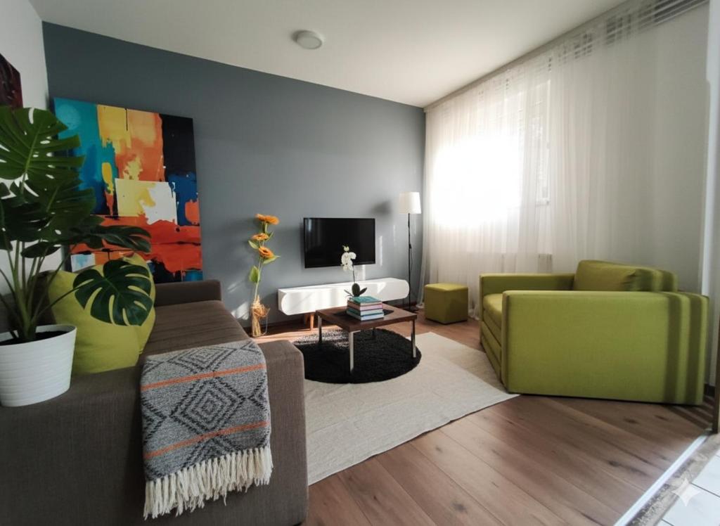 a living room with a couch and a tv at Fast Sleep & Go 1 in Paraćin