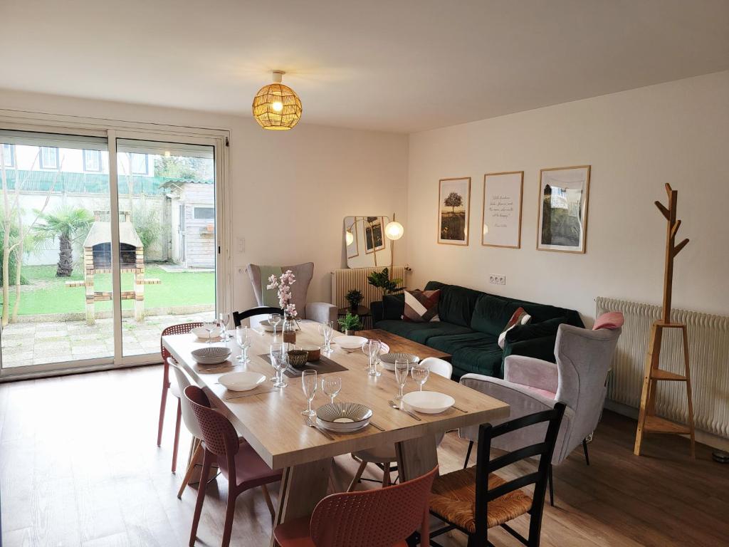 a living room with a table and a couch at Ernest Lodge Angers in Angers