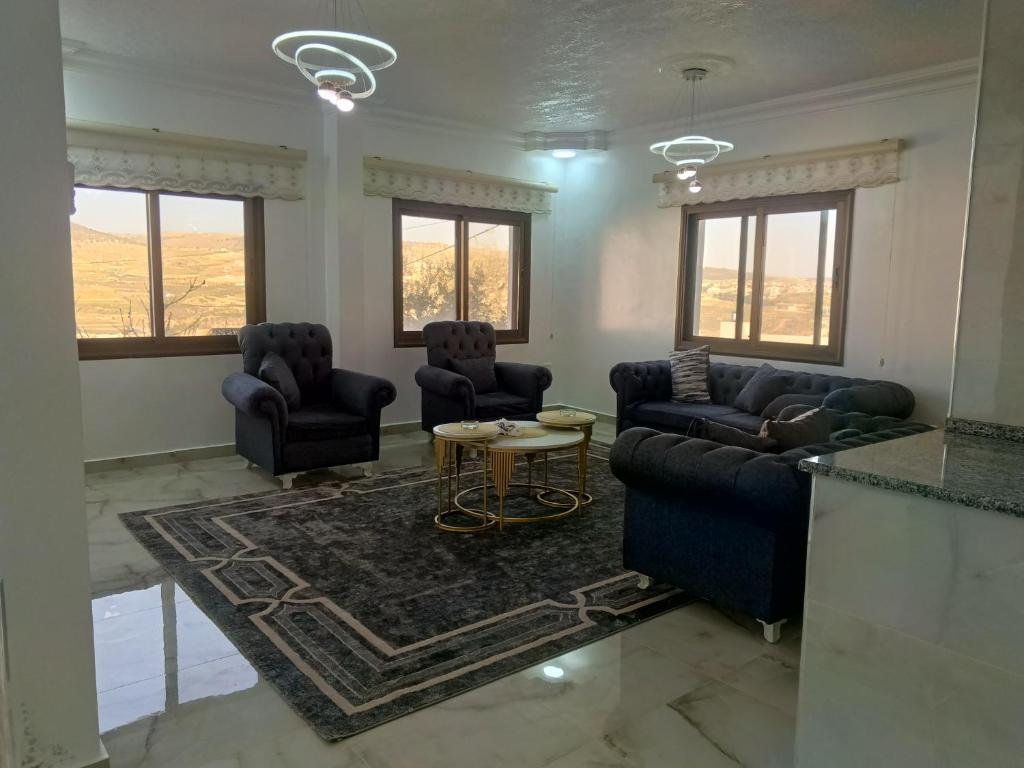 a living room with couches and a table at شقق العون in Jerash
