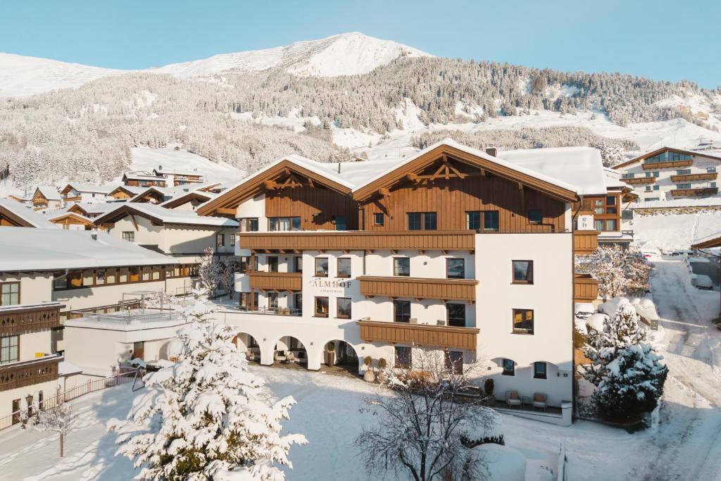 a resort in the mountains with snow on the ground at Apartement Almhof Fiss in Fiss