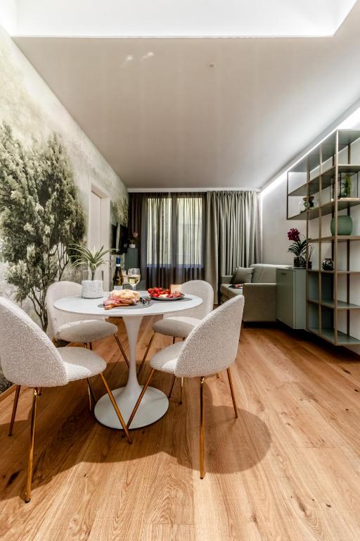 a living room with a table and chairs at Realkasa Kairos Luxury Apartments in Bologna
