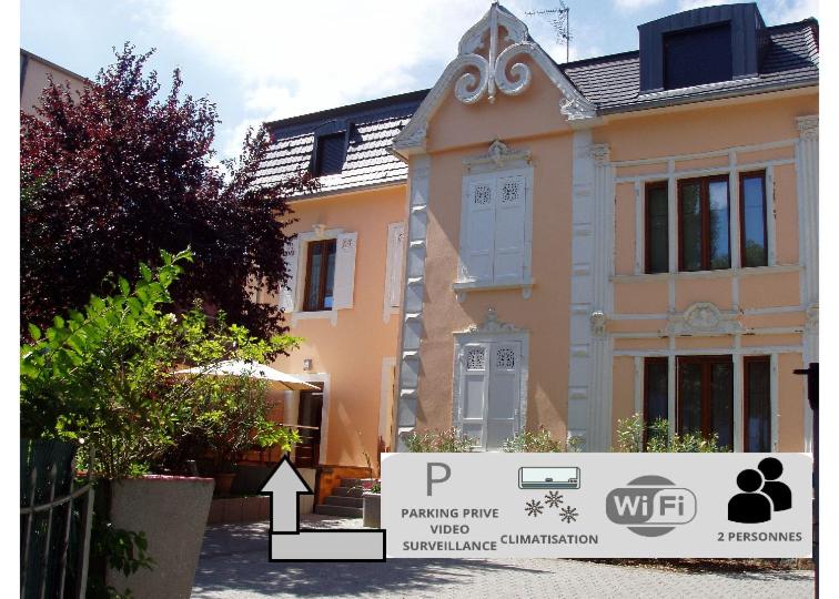 a house with a sign in front of it at Gites Du Ladhof in Colmar