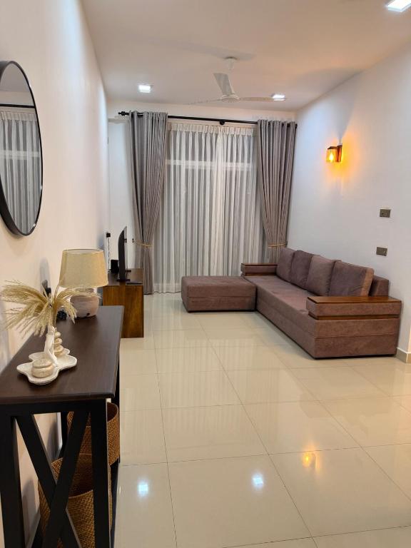 a living room with a couch and a table at 2BR luxury Apartment in Mount Lavinia - Benetia Stay in Mount Lavinia