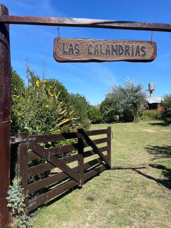 a sign that reads las cambias hangs over a fence at Las calandrias in Barrio Copacabana