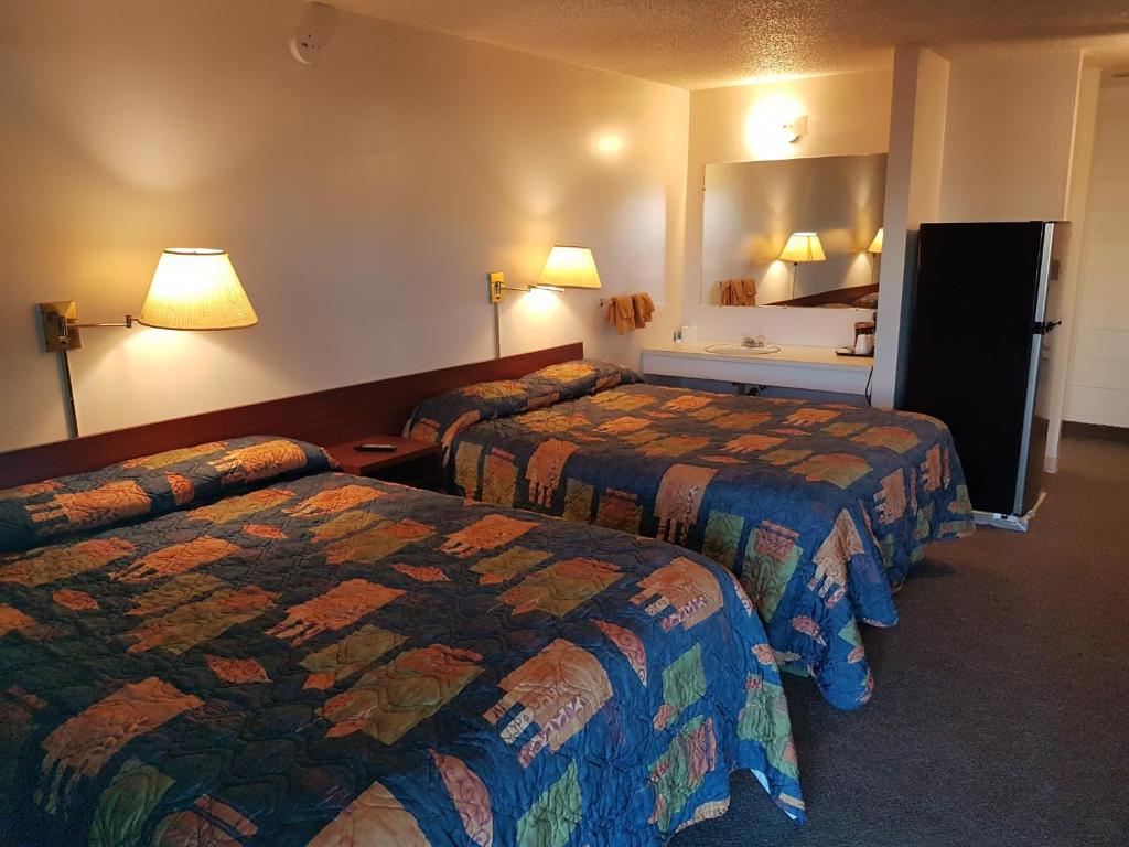 Postel nebo postele na pokoji v ubytování Shamrock Motel