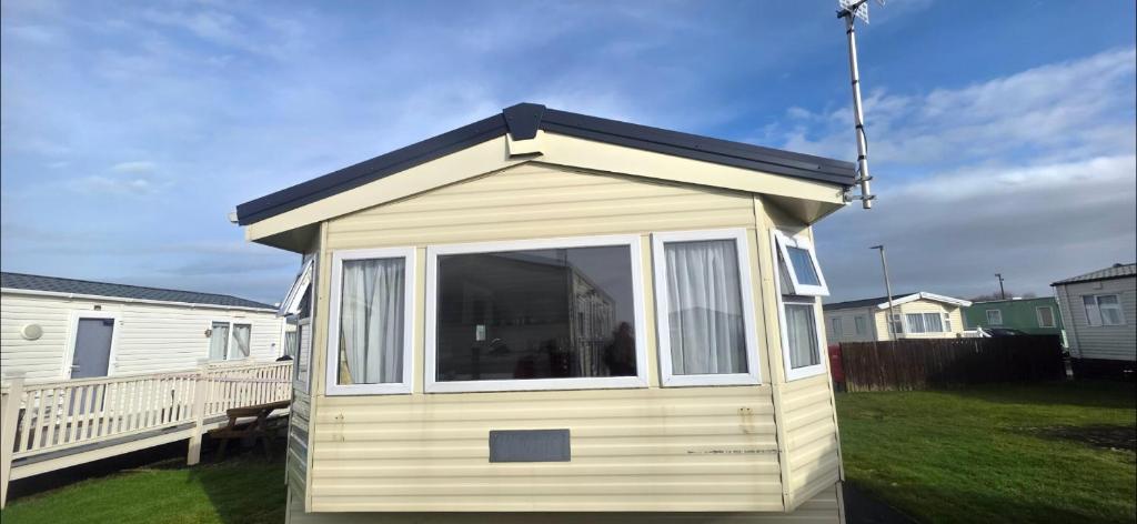 a small house with a window in a yard at BILOT Caravan in Heysham