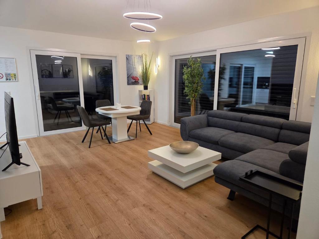 a living room with a couch and a table at Panorama Penthouse in Füssen