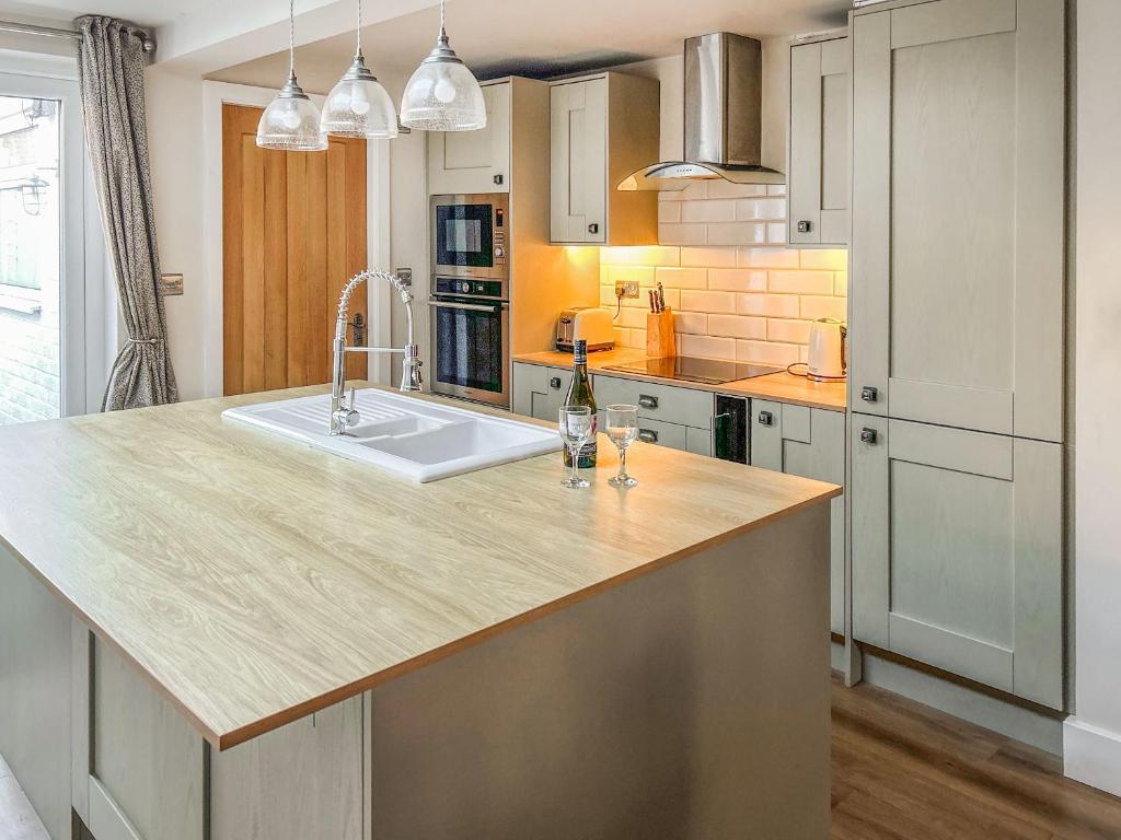 a kitchen with a large island with a sink at Willow Cottage in Beverley