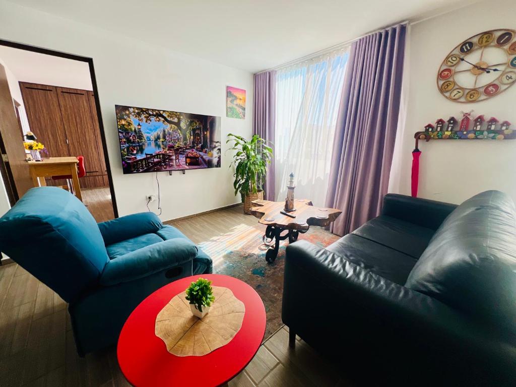 a living room with two blue couches and a table at Full Kitchen, Great View, Historic Center, Quiet in Puebla