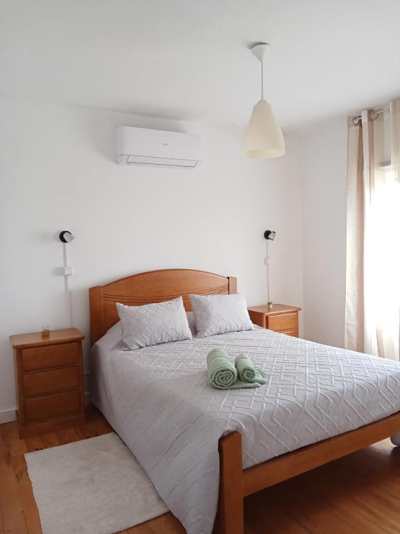 a bedroom with a bed with two towels on it at Casa da Eira - Alojamento Local in São João da Pesqueira