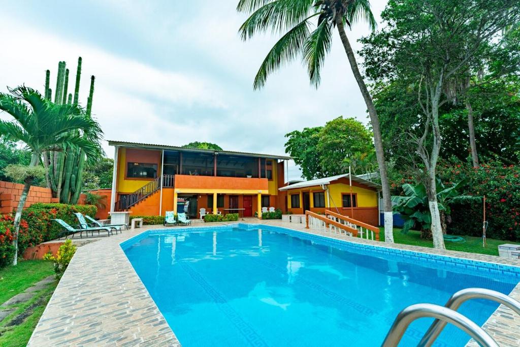 an exterior view of a house with a swimming pool at Casa Rector - Beach House Rental in El Roble