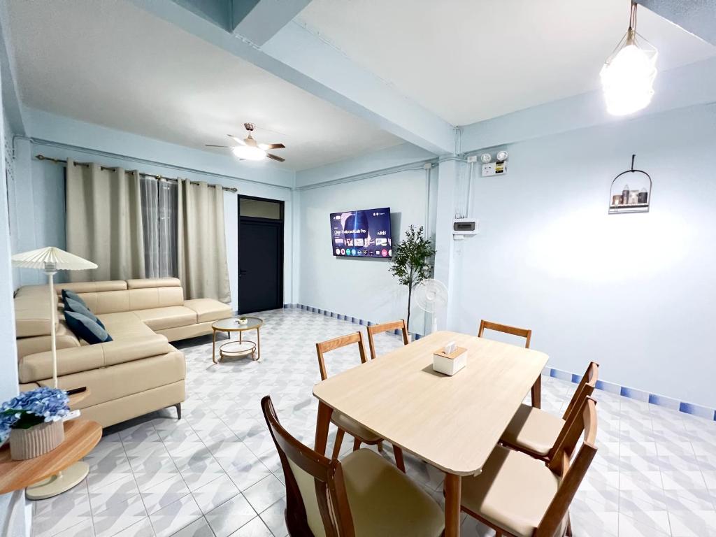 a living room with a table and a couch at S Home Hat Yai - Entire House, Private Parking in Hat Yai