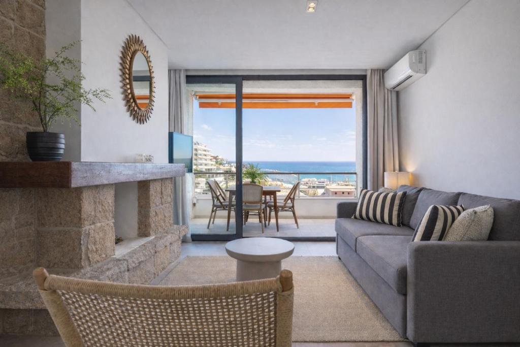 a living room with a couch and a fireplace at Nogalera Sea View Luxe in Torremolinos