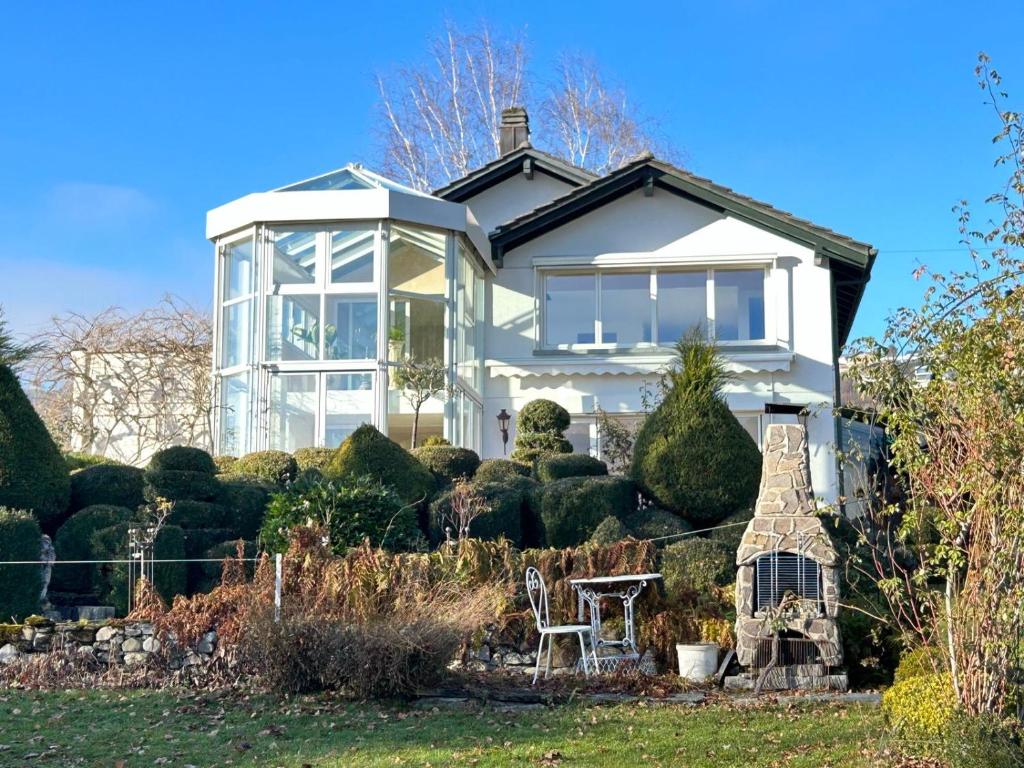a white house with a lot of windows at Rose Garden Switzerland in Avry devant Pont