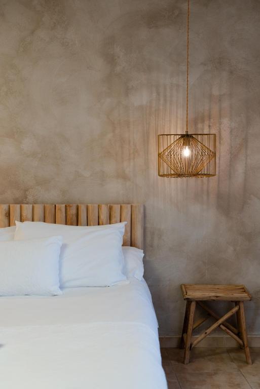 a bedroom with a bed and a pendant light at La Casa dels Abeuradors in Gandesa