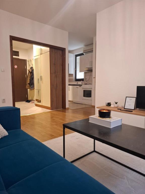 a living room with a couch and a table at Apartman Atlas in Doboj