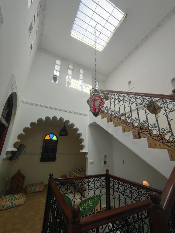 a staircase in a building with a stair case at Riad Privé Bkl luxury Dar Baroud in Tangier