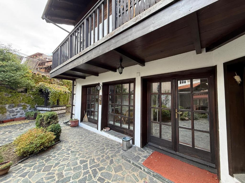 a building with glass doors and a balcony at White Wolf Chalet in Bansko