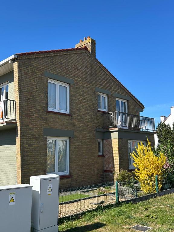a brick house with two refrigerators in front of it at Sea You Soon in De Haan