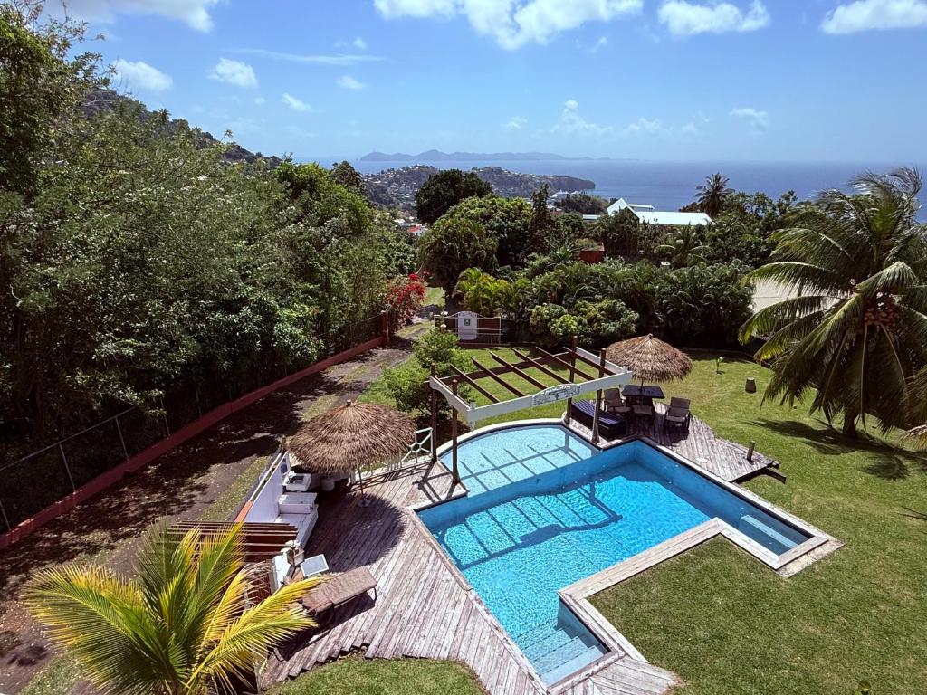 an image of a swimming pool in a yard at forst home with a great ocean view in Kingstown