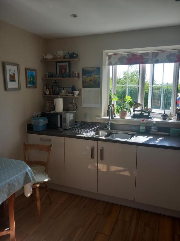 a kitchen with a sink and a window at Beautiful detached home in Evesham