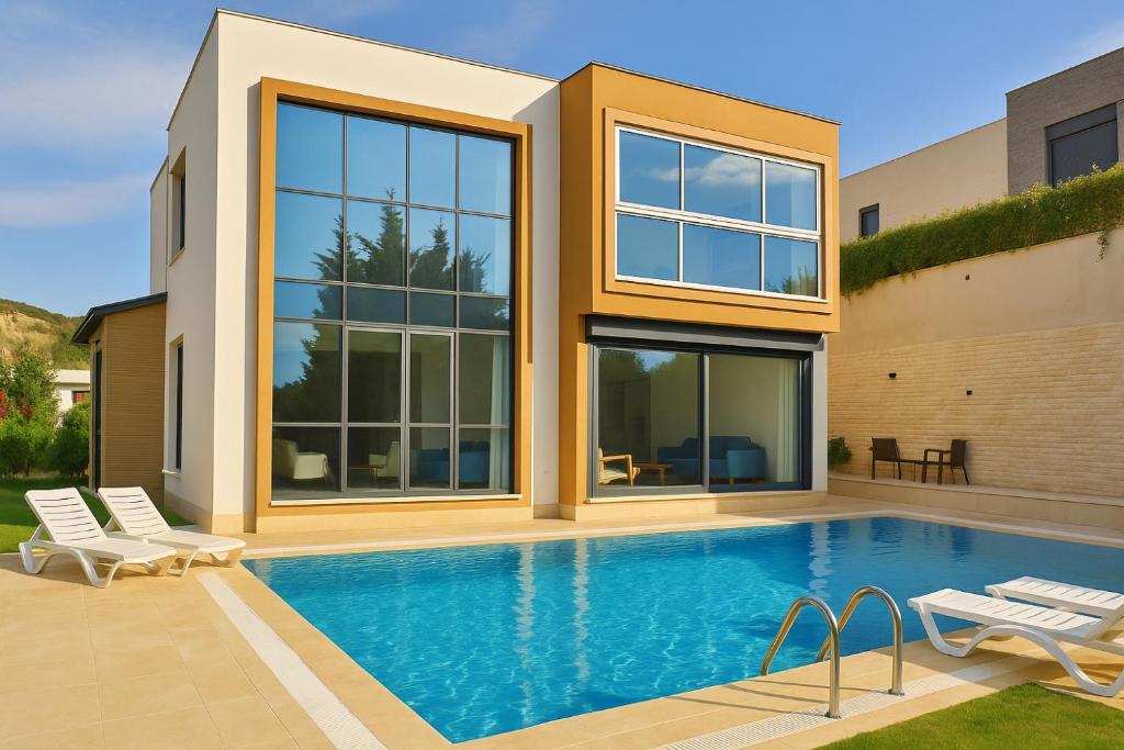 a house with a swimming pool in front of it at Villa Dream in Kuşadası