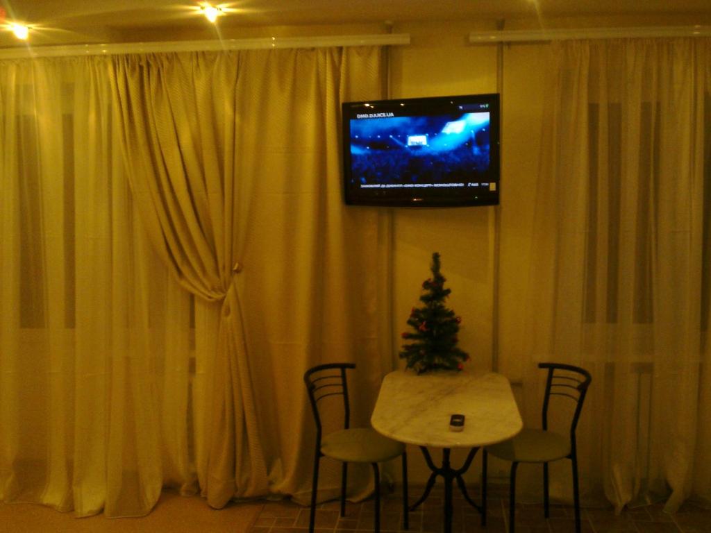 ドニプロにあるApartment at Kirova avenueの壁にテーブルとテレビが備わる部屋