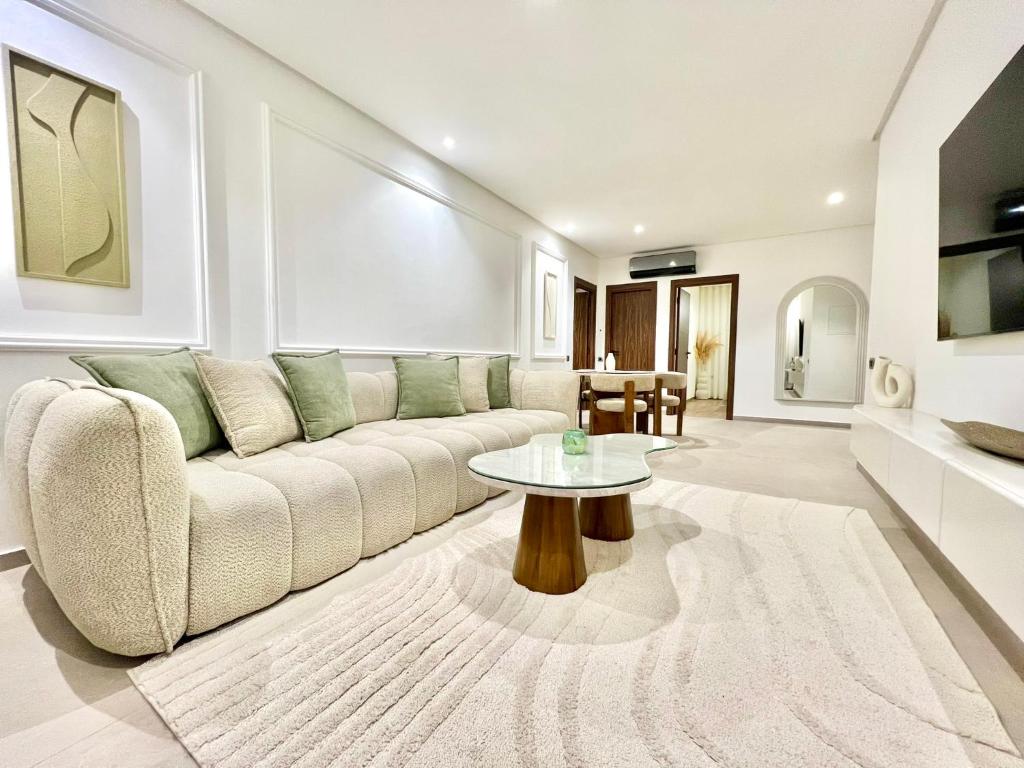 a living room with a couch and a table at Marrakech golf City prestigia in Marrakesh