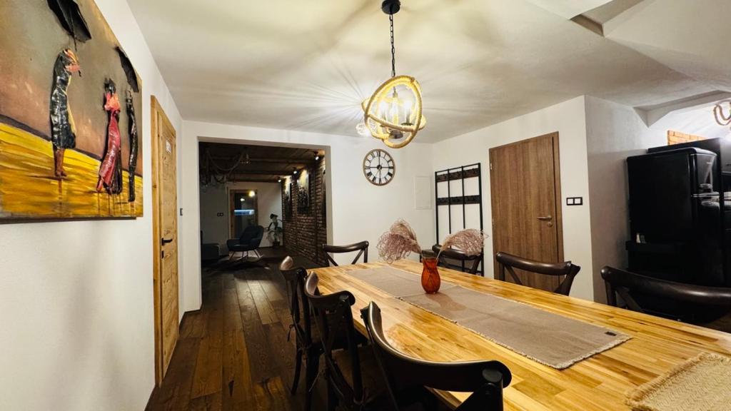a dining room with a wooden table and chairs at Apartmany FABRIK in Vysoká nad Kysucou