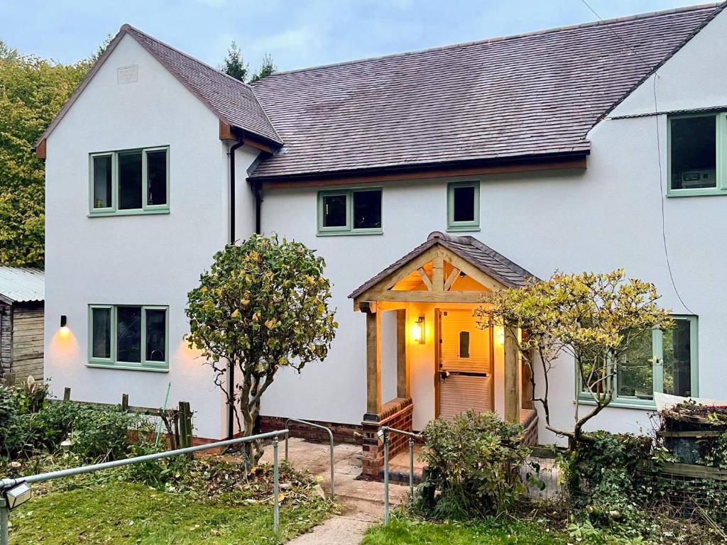 a white house with a wooden door at Cannock Chase in Rugeley
