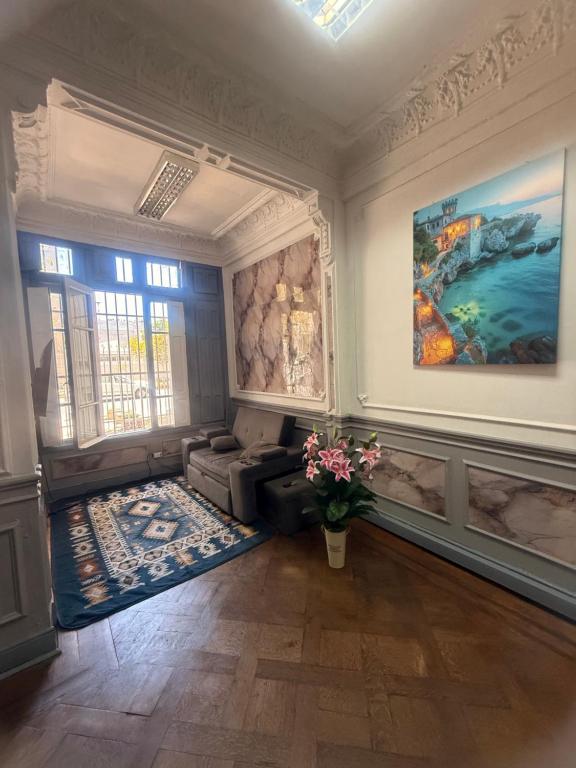 a living room with a couch and a painting on the wall at Familyhostel in Santiago