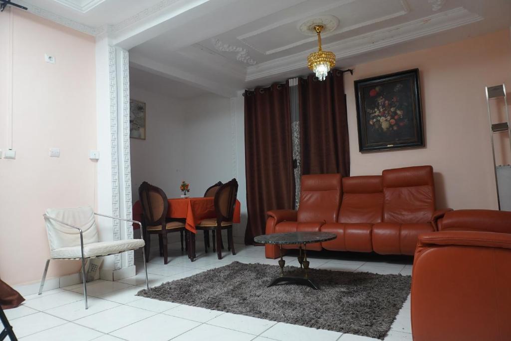 salon z kanapą i stołem w obiekcie Complexe A8CLOS w mieście Duala