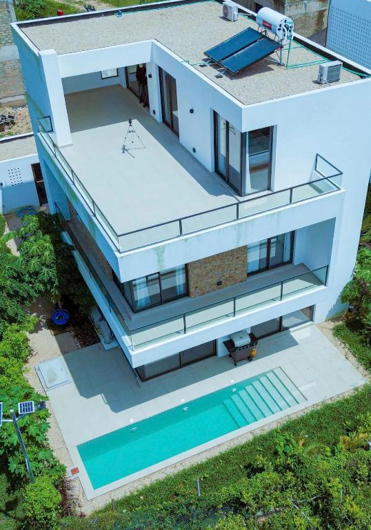 an aerial view of a house with a swimming pool at Bustani Villa in Nyamanzi Kazole