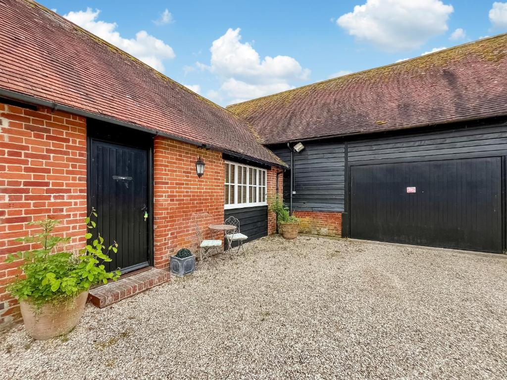 a garage with two garage doors and a driveway at Cottage 2 - Uk46612 in Broughton