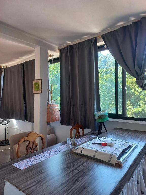 a room with a table and a large window at Estudio La Higuera in Yelapa