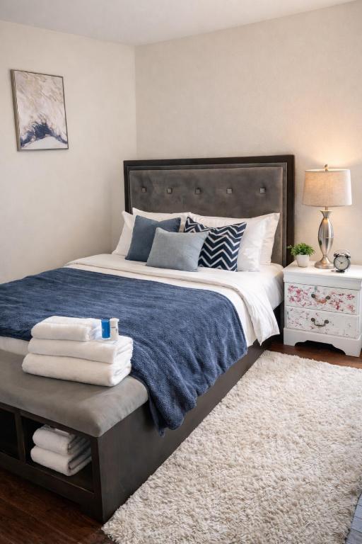 a bedroom with a large bed with a blue blanket at Carson in Carson