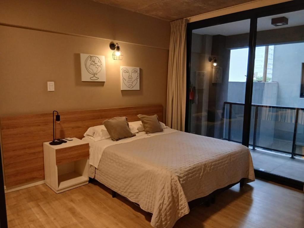 a bedroom with a bed and a large window at zona balcarce in Salta