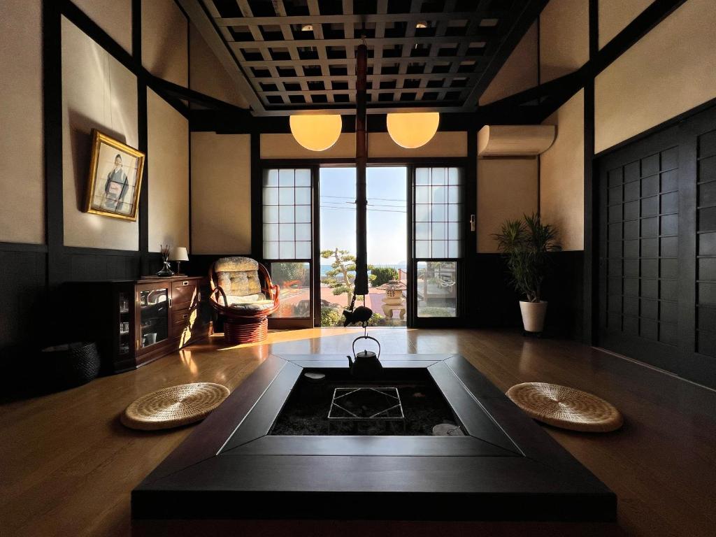 a large room with a table in the middle at Beachfront Irori in Suo Oshima