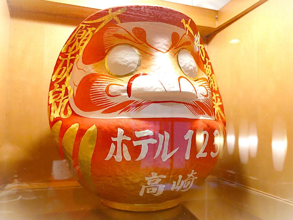 a vase with a face on it sitting on a table at Hotel 1-2-3 Takasaki in Takasaki