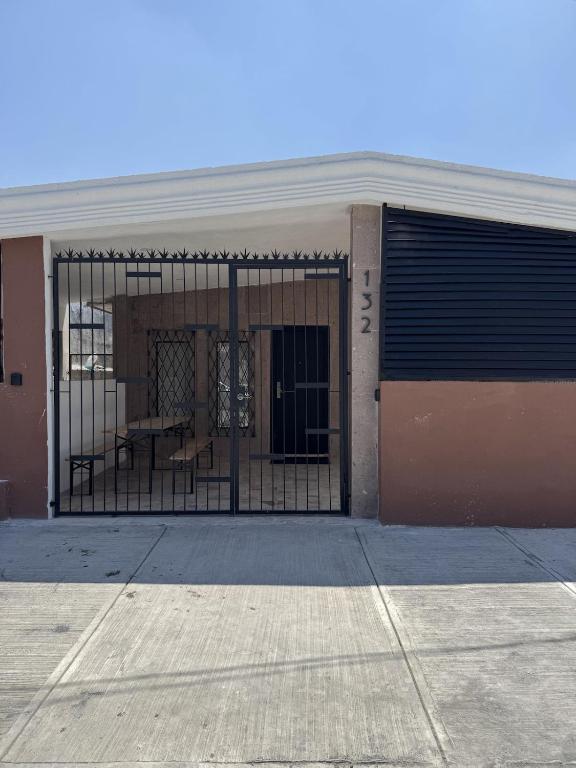 a garage door with a gate in front of a building at Equipped apartment in industrial area in Ciudad Satelite del Norte