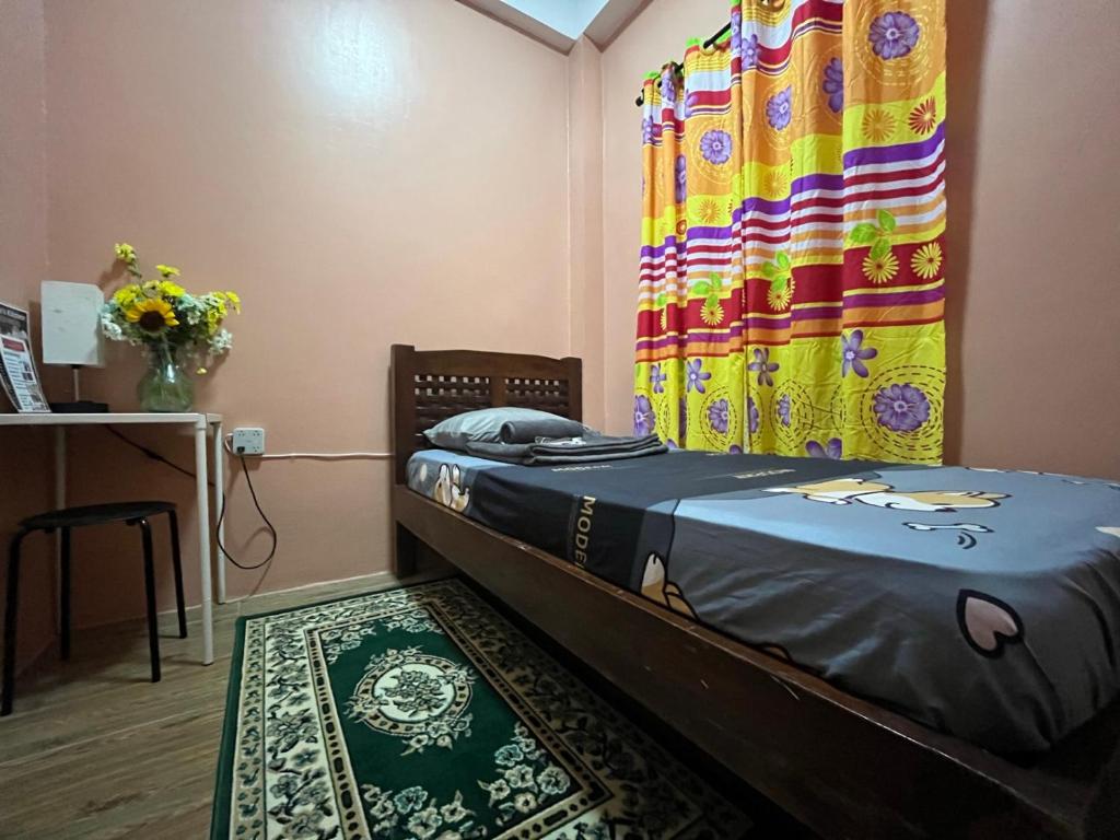 a small room with a bed and a curtain at Tipid Camp Baguio A4,A5,A6 in Baguio