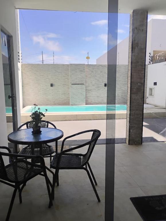 a table and chairs with a potted plant on a patio at Mirian nascimento in Camaçari
