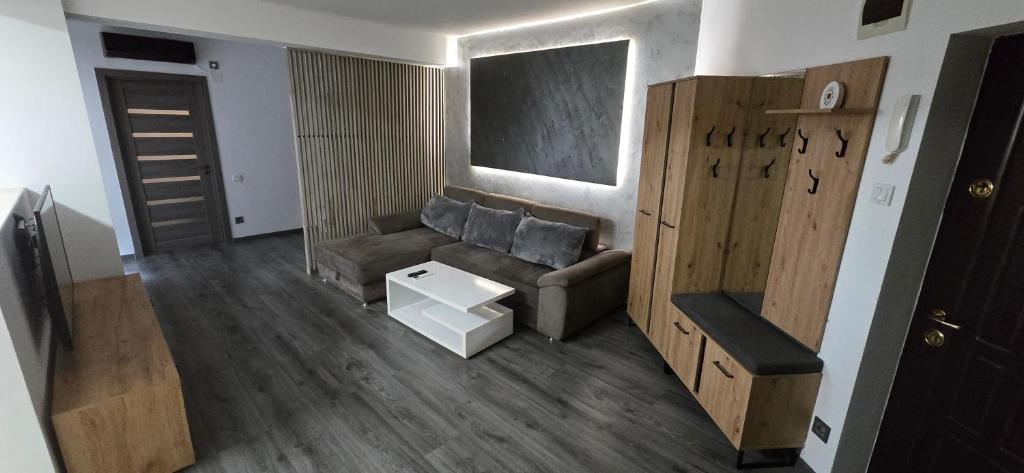 a living room with a couch and a table at Dumitra Place in Cluj-Napoca