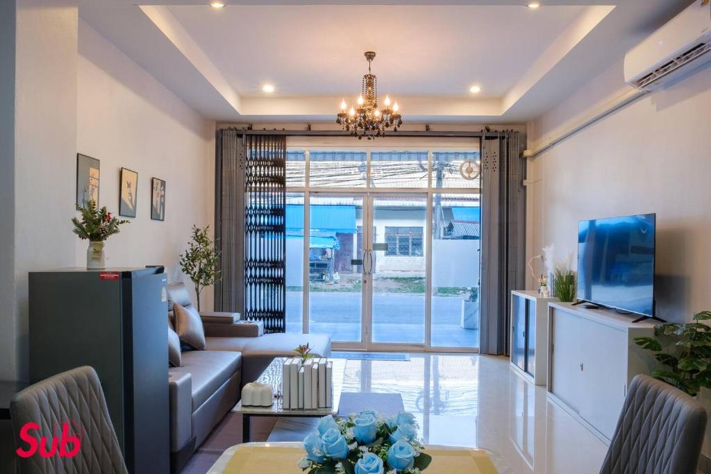 a living room with a couch and a table at Dream Home in Hat Yai in Ban Kohong