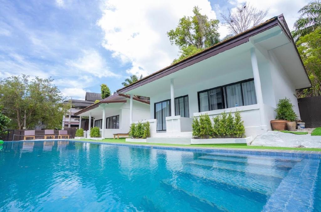 an image of a swimming pool in front of a house at The BRC Ao-nang Hotel in Ao Nang Beach